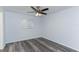 Bedroom features stylish wood-look flooring, ceiling fan, and window at 205 Elaine Pl, Chuluota, FL 32766