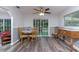 Charming dining area featuring wood floors, natural light, and a view of the backyard at 205 Elaine Pl, Chuluota, FL 32766