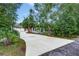 Paver driveway leading to a well-maintained home with a visible attached garage and ample parking at 205 Elaine Pl, Chuluota, FL 32766