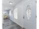 Inviting entryway featuring glass paneled front door and hardwood flooring at 205 Elaine Pl, Chuluota, FL 32766