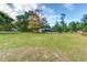 Lush lawn, mature trees and charming single-story home offer tranquil outdoor living at 205 Elaine Pl, Chuluota, FL 32766