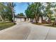 Inviting single-story home with a spacious driveway, complemented by lush greenery at 205 Elaine Pl, Chuluota, FL 32766