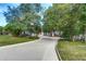 Charming home with lush landscaping, mature trees, and a long driveway at 205 Elaine Pl, Chuluota, FL 32766
