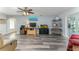 Bright living room with hardwood floors and a decorative entertainment center at 205 Elaine Pl, Chuluota, FL 32766
