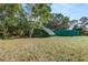 Backyard area showcasing outbuildings, including a shed and utility trailer at 205 Elaine Pl, Chuluota, FL 32766