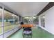 Spacious screened-in patio with table, chairs, and lush backyard views at 205 Elaine Pl, Chuluota, FL 32766