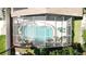 Aerial view of a sparkling pool, enclosed in a screened patio, surrounded by greenery at 2343 Walnut Heights Rd, Apopka, FL 32703