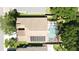 Aerial view of a home featuring a screened-in pool, solar panels, and lush landscaping at 2343 Walnut Heights Rd, Apopka, FL 32703