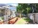 Backyard with a manicured lawn, a screened-in patio, landscaping, and fenced perimeter at 2343 Walnut Heights Rd, Apopka, FL 32703