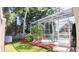 Backyard features a lawn, landscaping, and a screened-in patio with views of the pool at 2343 Walnut Heights Rd, Apopka, FL 32703