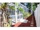 Backyard features mulched garden area, a screened-in patio, and direct access to the pool at 2343 Walnut Heights Rd, Apopka, FL 32703