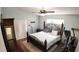 Comfortable bedroom featuring a large bed, ceiling fan, and ample natural light with wood-look floors at 2343 Walnut Heights Rd, Apopka, FL 32703
