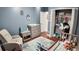bedroom features wood-look floors, comfortable seating, and easy access to an ample closet at 2343 Walnut Heights Rd, Apopka, FL 32703