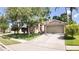 Beautiful single Gathering home with well maintained lawn, driveway, mature trees, and 2-car garage at 2343 Walnut Heights Rd, Apopka, FL 32703
