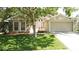 Charming home featuring a well-manicured lawn, mature trees, and attached two-car garage at 2343 Walnut Heights Rd, Apopka, FL 32703