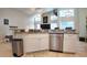 Bright kitchen featuring stainless steel appliances, granite counters, and white cabinets at 2343 Walnut Heights Rd, Apopka, FL 32703