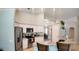 Bright kitchen features granite countertops, stainless steel appliances, white cabinets, and a breakfast bar at 2343 Walnut Heights Rd, Apopka, FL 32703