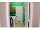 Bright laundry room features a washing machine, tile flooring, and convenient access door at 2343 Walnut Heights Rd, Apopka, FL 32703
