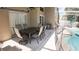 Outdoor patio with seating area and views of the pool in a screened enclosure at 2343 Walnut Heights Rd, Apopka, FL 32703