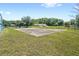 Community basketball court with well-maintained surroundings and mature trees at 2409 Pinyon Ct, Kissimmee, FL 34746