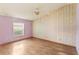 Bedroom with wood floors and a large window providing natural light at 2409 Pinyon Ct, Kissimmee, FL 34746