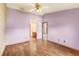 Bedroom features wood floors, a ceiling fan, and an en-suite bathroom at 2409 Pinyon Ct, Kissimmee, FL 34746