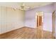 Bedroom featuring wood floors, a ceiling fan, and an attached bathroom at 2409 Pinyon Ct, Kissimmee, FL 34746
