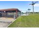 Community outdoor entertainment space, with tables and chairs, pool, and palm trees at 2409 Pinyon Ct, Kissimmee, FL 34746