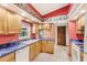 Kitchen featuring wood cabinetry, tile floors, and modern appliances at 2409 Pinyon Ct, Kissimmee, FL 34746