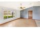 Bright living room with hardwood floors, a large window, and a ceiling fan at 2409 Pinyon Ct, Kissimmee, FL 34746