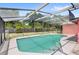 Relax in this screened pool with a spacious deck, surrounded by lush backyard landscaping at 2409 Pinyon Ct, Kissimmee, FL 34746