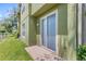 Exterior view of the back of the house, with a sliding glass door and a grassy backyard at 2430 Little Gem Loop, Sanford, FL 32773