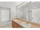 A bright bathroom with double sinks, large mirror, and shower; a clean and functional space at 2430 Little Gem Loop, Sanford, FL 32773