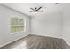 Serene bedroom with wood-look flooring and ample natural light through the window at 2430 Little Gem Loop, Sanford, FL 32773