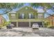 Three-story townhouse with balconies over garages and mature landscaping around the property at 2430 Little Gem Loop, Sanford, FL 32773