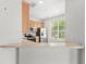 View of kitchen area, featuring stainless appliances, wood cabinets, and a breakfast bar at 2430 Little Gem Loop, Sanford, FL 32773