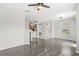 Open living room with sleek wood-look floors, complemented by modern light fixtures and neutral tones at 2430 Little Gem Loop, Sanford, FL 32773