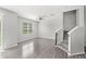 Spacious living area featuring wood-look flooring and a staircase leading to the upper level at 2430 Little Gem Loop, Sanford, FL 32773