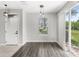 Bright living space featuring wood-look flooring, sliding doors, and a view of the outdoors at 2430 Little Gem Loop, Sanford, FL 32773