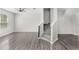 Comfortable living room with wood-look flooring, a staircase, and natural light from the windows at 2430 Little Gem Loop, Sanford, FL 32773
