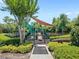 Community playground featuring slides, climbing structures, and shaded areas for children to enjoy at 2430 Little Gem Loop, Sanford, FL 32773