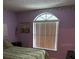 Bedroom featuring a comfortable bed, window with blinds, and soft ambient lighting at 25306 Northlake Dr # 25306, Sanford, FL 32773