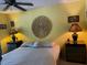 Bright bedroom with yellow walls, ceiling fan, decorative wall art, and a comfortable bed with bedside tables at 25306 Northlake Dr # 25306, Sanford, FL 32773