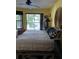 Cozy bedroom with view of lake, featuring ceiling fan and large windows at 25306 Northlake Dr # 25306, Sanford, FL 32773