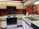 Kitchen with white cabinets, tile floors, and black appliances at 25306 Northlake Dr # 25306, Sanford, FL 32773