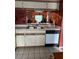Kitchen with white cabinets, tile floors and a black dishwasher at 25306 Northlake Dr # 25306, Sanford, FL 32773