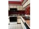 Kitchen with white cabinets, tile floors, and black appliances at 25306 Northlake Dr # 25306, Sanford, FL 32773