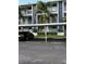 Assigned covered parking spot in front of condo building with palm trees at 25306 Northlake Dr # 25306, Sanford, FL 32773