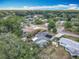 An elevated view shows a lush community with mature trees, pools, sheds, landscaping and homes at 2550 Meadowview Ln, Deland, FL 32720