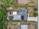 Bird's eye view of a home with a large pool, patio, shed, and landscaping at 2550 Meadowview Ln, Deland, FL 32720